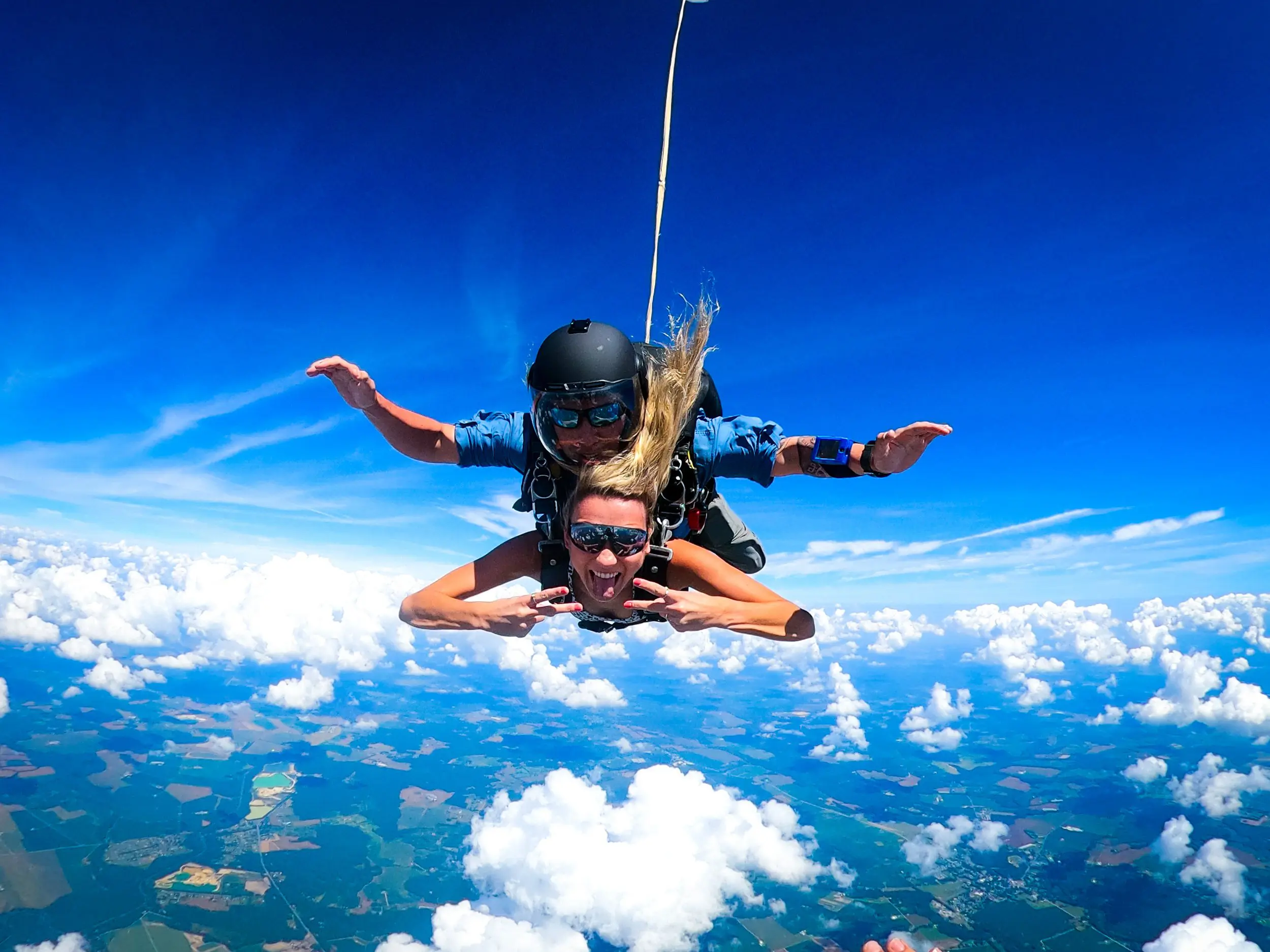 SKYDIVE-HOME tandem skydiver smiles in freefall